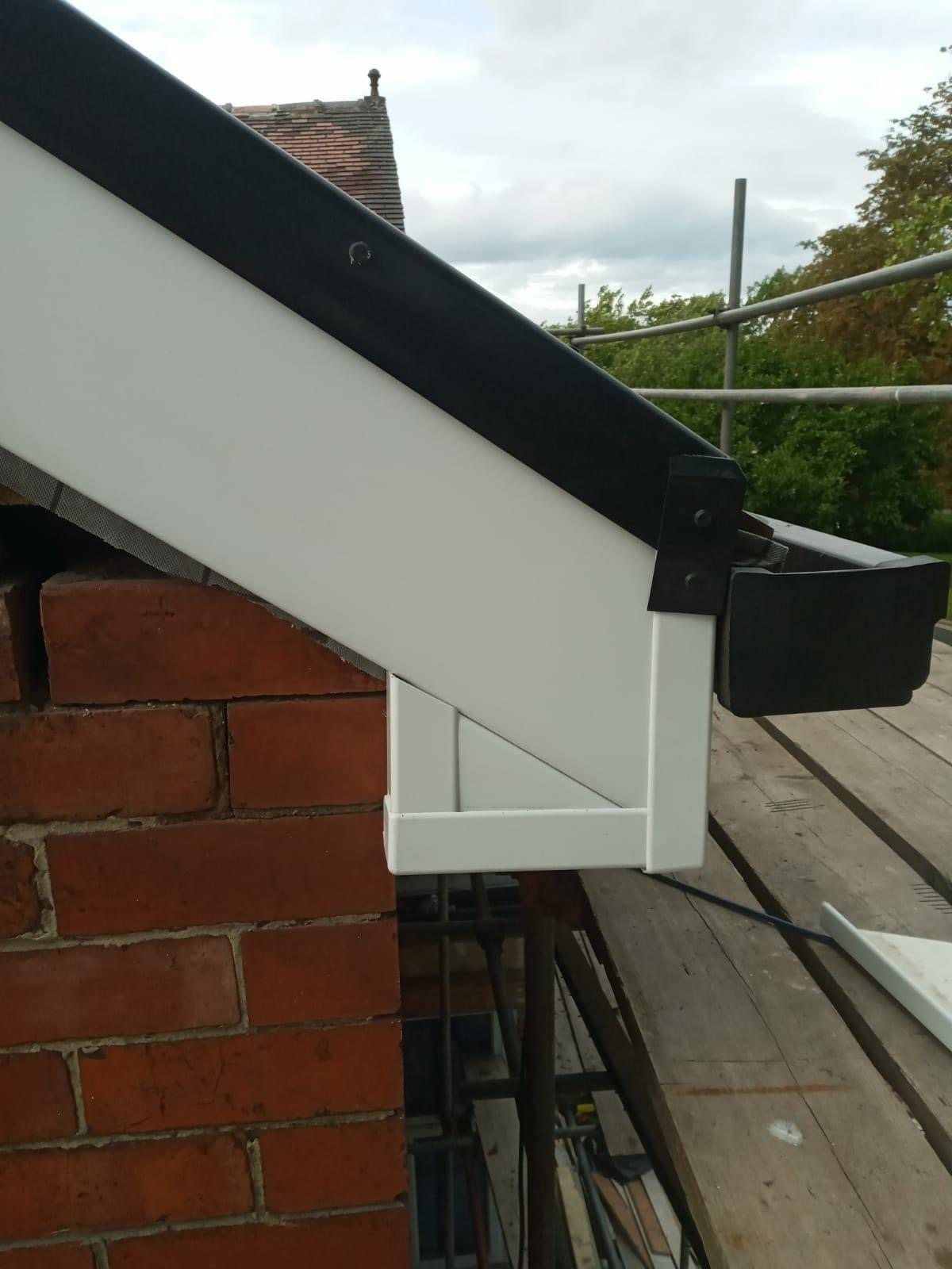 Roof verge box end where fascia, soffit and gutter meet the brickwork