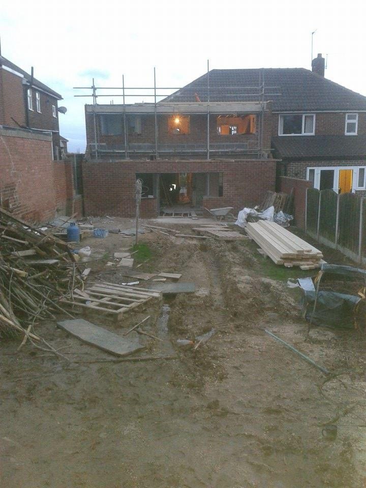 Brick shell of a two-storey rear extension ready for its new roof