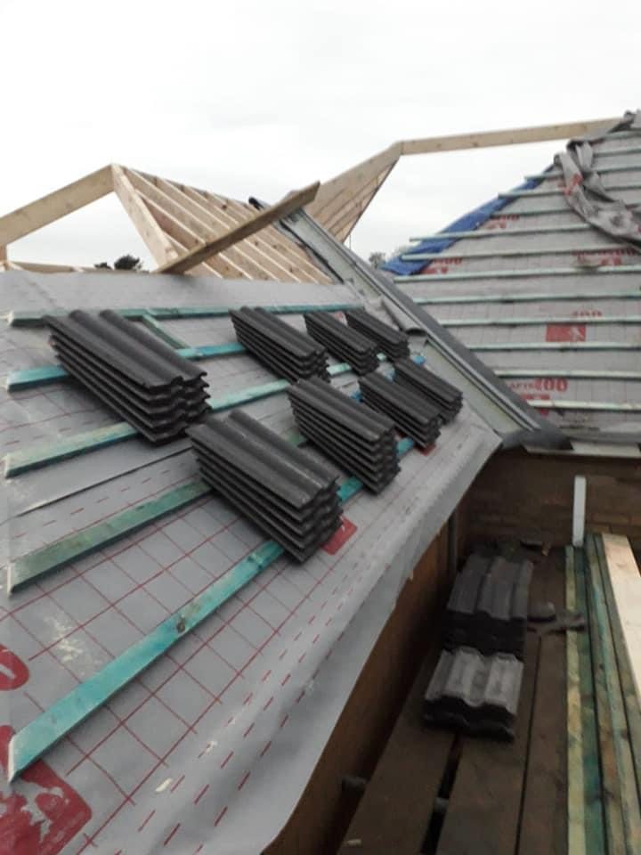 Breathable roofing membrane, treated battens and tiles loaded out on a roof